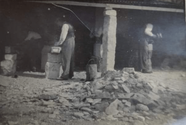 Stonemason Working on a Stone Wall Repair